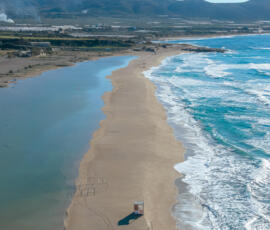 Gentle waves flowing across the shoreline at Falassarna Beach, capturing the movement of the Cretan coast. Shallow waves washing over the sand at Falassarna Beach in western Crete, viewed from above.