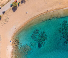 The rocky shoreline and clear waters of Viglia Beach, Kissamos. Aerial photograph of Viglia Beach in Kissamos showing rocky coast and turquoise sea.