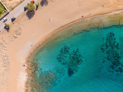 The rocky shoreline and clear waters of Viglia Beach, Kissamos. Aerial photograph of Viglia Beach in Kissamos showing rocky coast and turquoise sea.